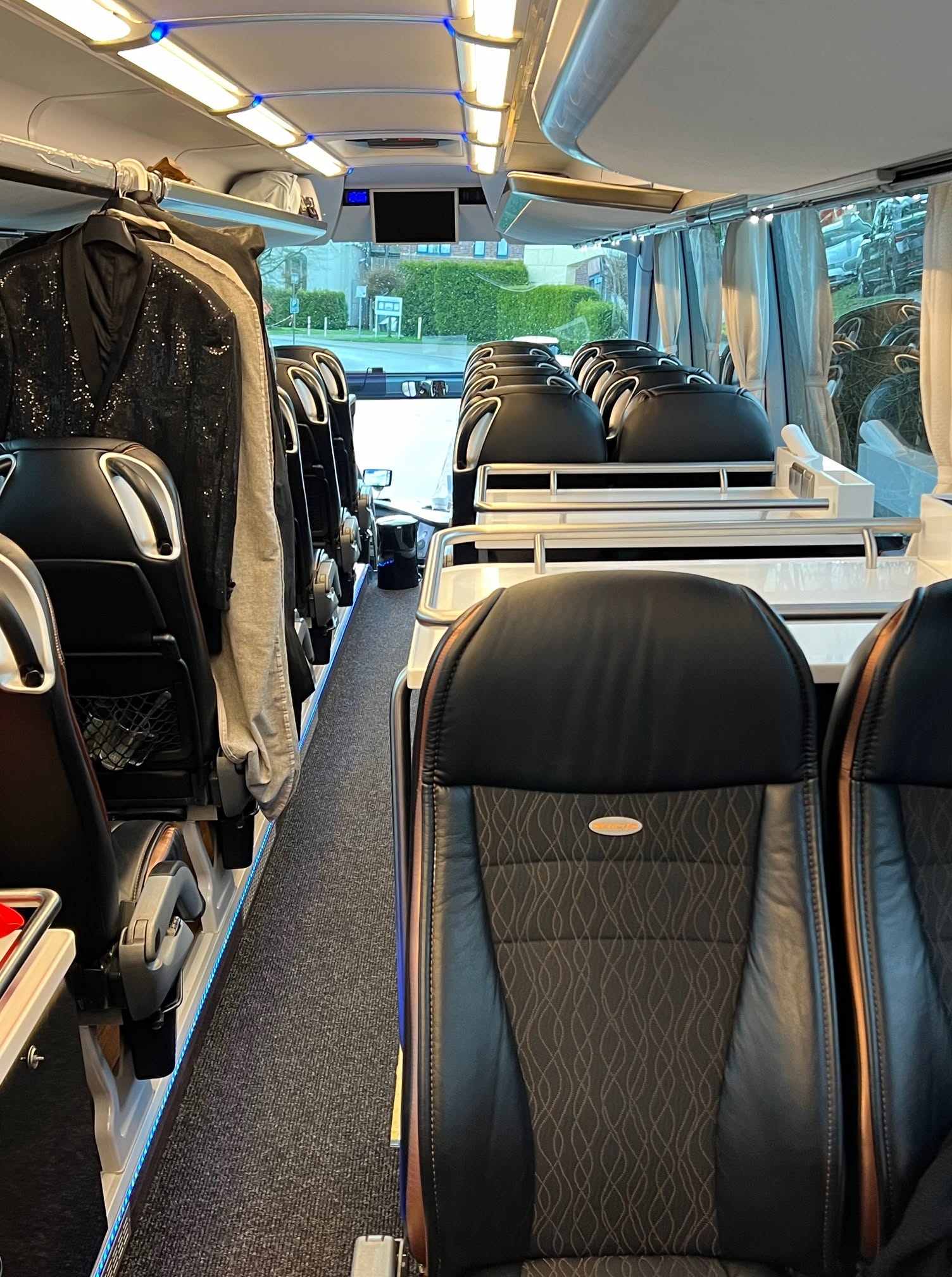 Concert garments on rail inside tour coach