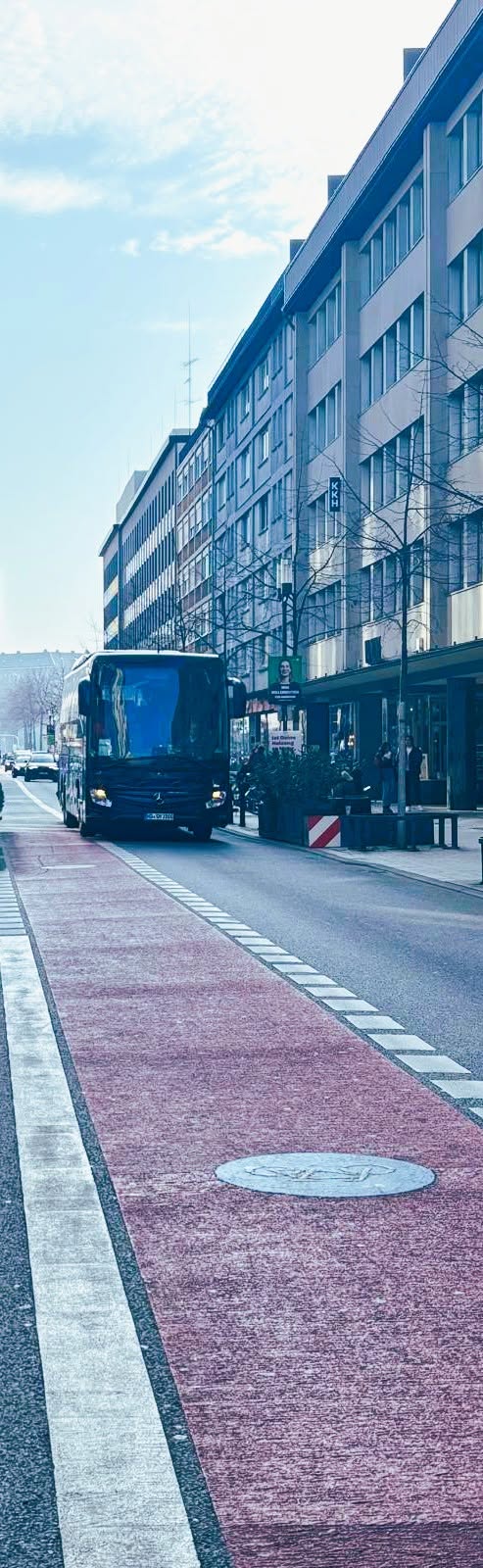 Tour coach navigating a European city centre